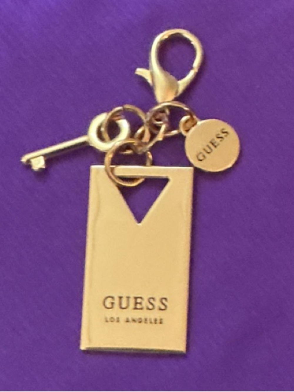 Guess Gold-tone Logo Charm Keychain on Purple